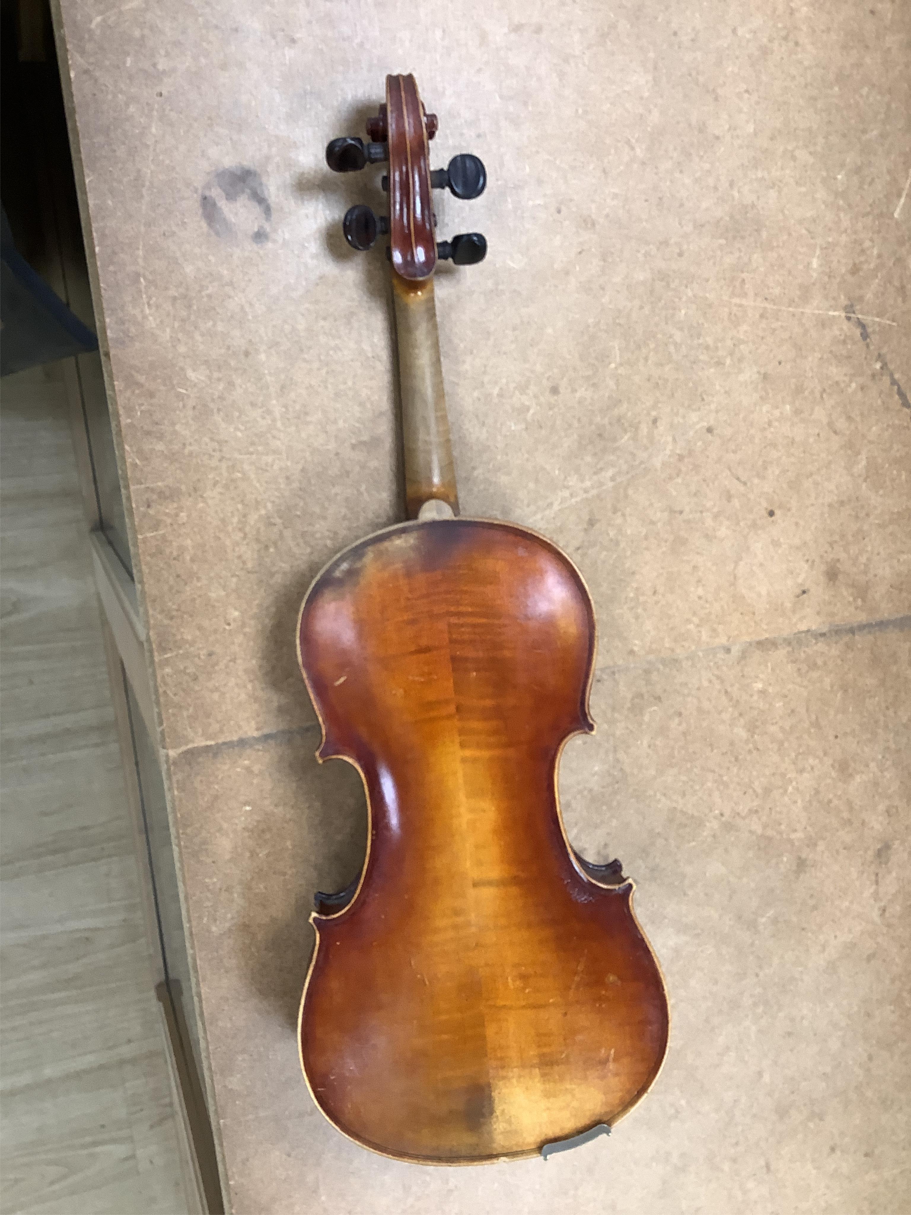 An early 20th century cased violin and cover, 60cm long